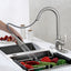 Alexis faucet with 20 inch reach rinsing off vegetables in a kitchen sink.